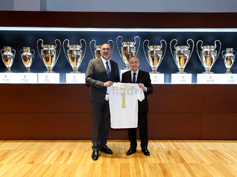 Representatives from Real Madrid and Telefonica holding one shirt as sign of partnership